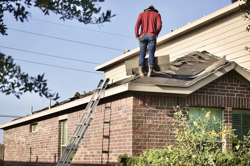 Professional roofer working on a residential roof in The Old Derby Estates